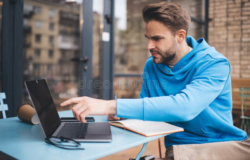 Caucaisan student 20s research education information on modern laptop computer using 4g wireless for browsing, skilled hipster guy with notepad e learning via application on digital netbook technology. Caucaisan man stock images, royalty-free photos and pictures