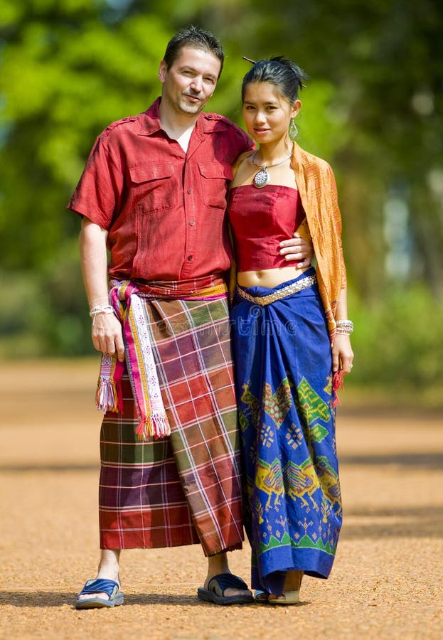 Caucasian and asian with traditional thai clothes