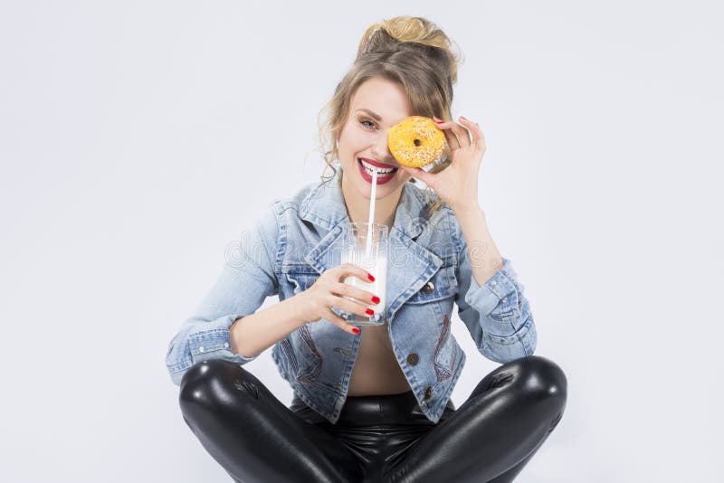 Caucasian Blond Girl Having Fun with Cup of MIlk and Donut Bagel