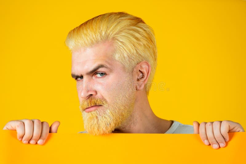 Caucasian blond male model posing in fashion concept studio shoot. Happy middle age man presenting empty paper. Man stock photos Caucasian blond male model posing in fashion concept studio shoot. Happy middle age man presenting empty paper. Man stock photos