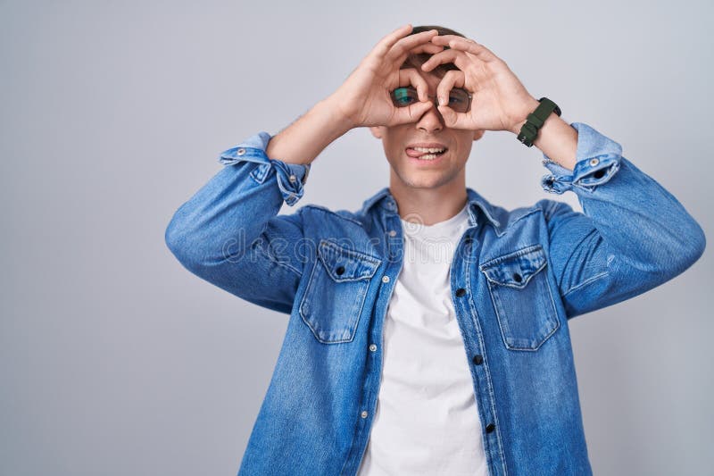 Caucasian Blond Man Standing Wearing Glasses Doing Ok Gesture Like caucasian-blond-man-standing-wearing-glasses-doing-ok-gesture-like