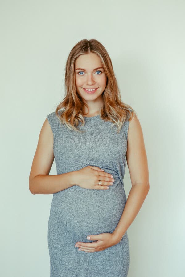 Caucasian Blonde Pregnant Woman In Grey Dress Touching Her Belly Stock Image Image Of Adult