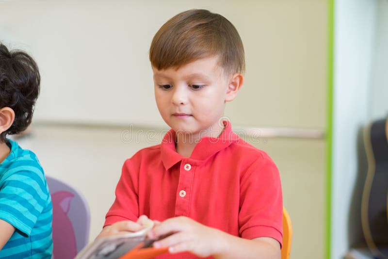 Caucasian boy ethnicity kid learning in classroom with friends a royalty free stock photography Caucasian boy ethnicity kid learning in classroom with friends a royalty free stock photography