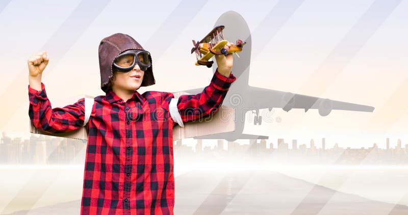 Caucasian boy wearing aviator hat and googles flying toy airplane and airplane taking off at runway stock images