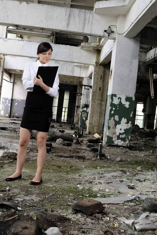 caucasian business woman evaluating building