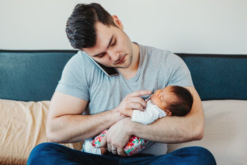 Caucasian Father Dad with Newborn Mixed Race Asian Chinese Baby Working from Home Stock Image