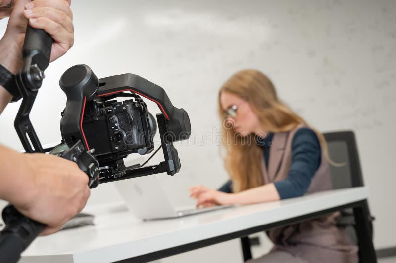 Caucasian female scientist typing on laptop. White board with formulas. Photo shoot. stock image
