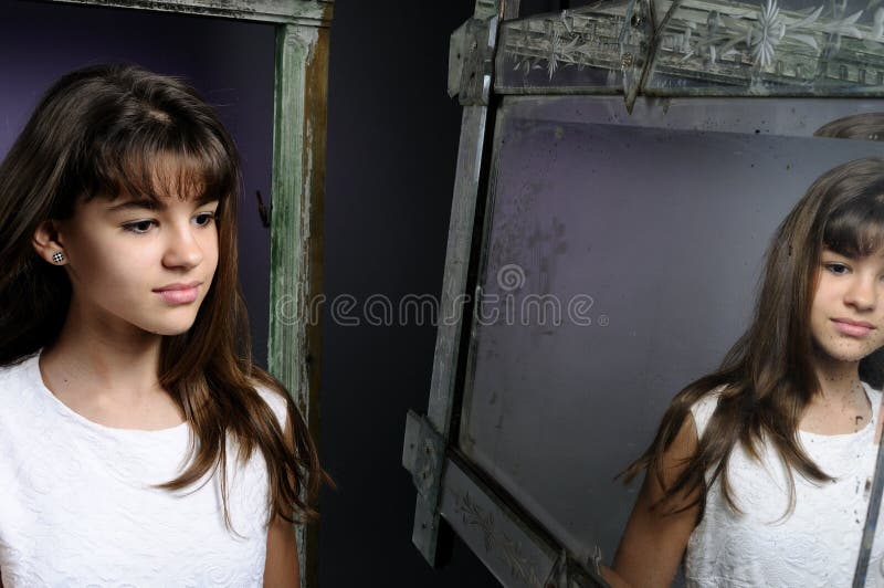 Caucasian girl looking in mirror