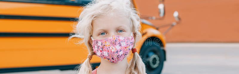 Caucasian girl student wearing face mask by yellow school bus. Kid with personal protective equipment. Education and back to stock image Caucasian girl student wearing face mask by yellow school bus. Kid with personal protective equipment. Education and back to stock image