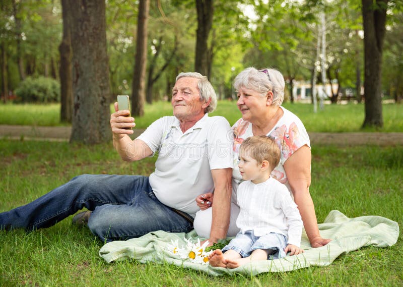 Caucasian grandparent with grandson having video chatting with family