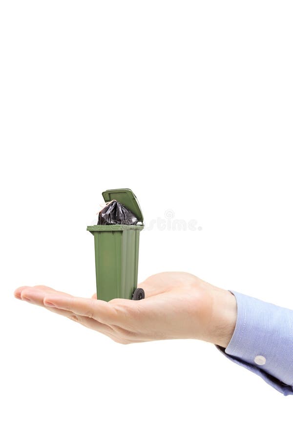 Caucasian hand holding a green trash can royalty free stock image