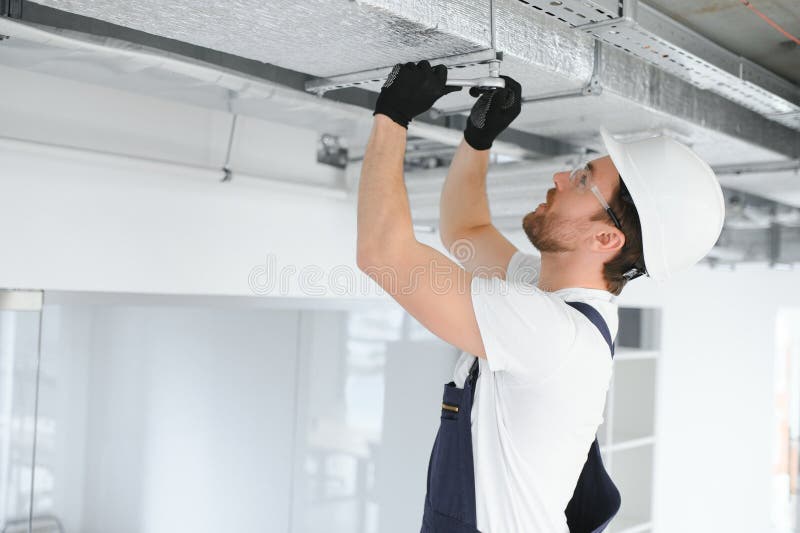 Caucasian HVAC Technician Worker in His 40s Testing Newly Installed