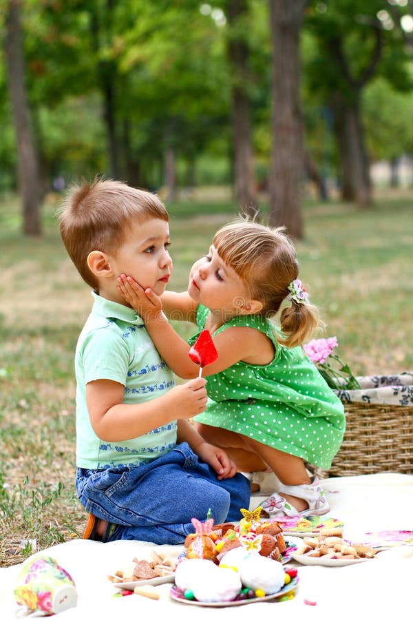 Caucasian little boy and girl eating sweets