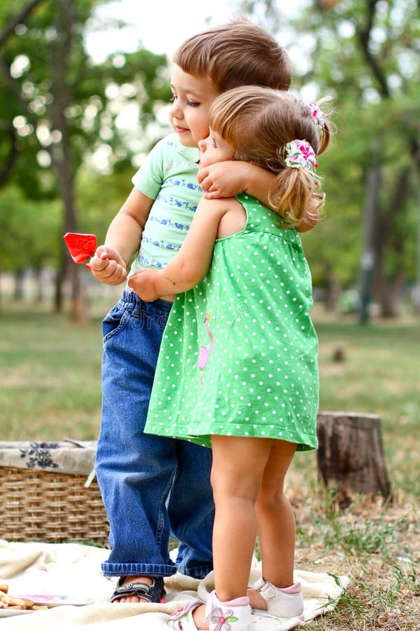 Caucasian little boy and girl eating sweets