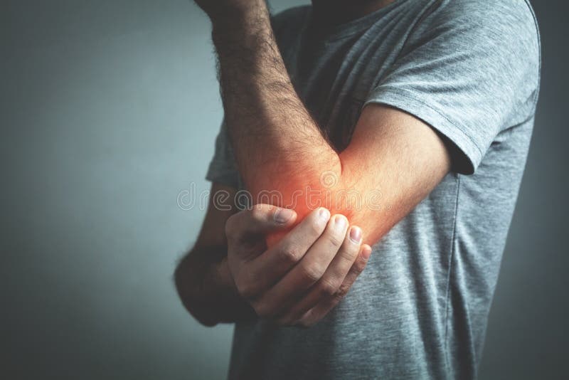 Caucasian man with elbow pain. Pain relief concept royalty free stock image