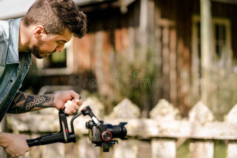 Caucasian man filming with professional gimbal with camera royalty free stock photos