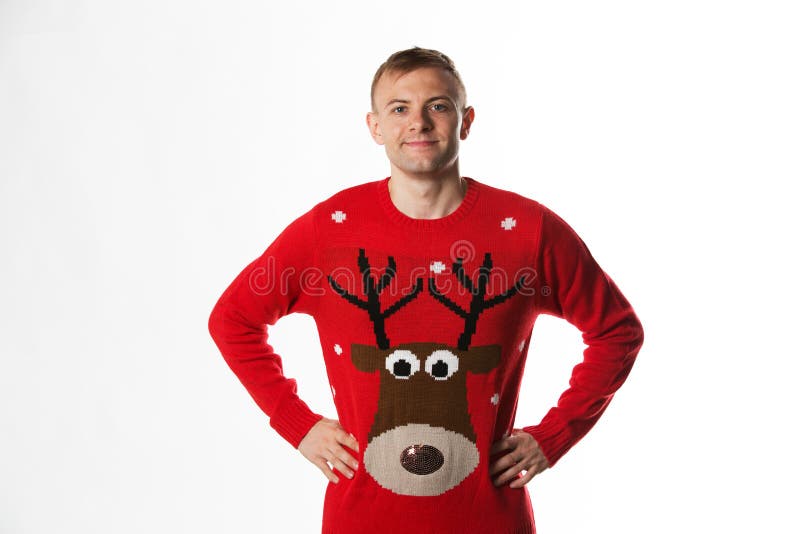 Caucasian man with hand on hips whilst wearing a christmas jumper