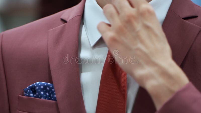 Caucasian Man Hands Corrected Red Tie On A White Shirt