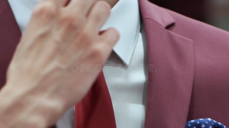 Caucasian Man Hands Corrected Red Tie On A White Shirt