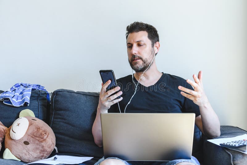 Caucasian man sitting in sofa and talking by phone stock photos Caucasian man sitting in sofa and talking by phone stock photos