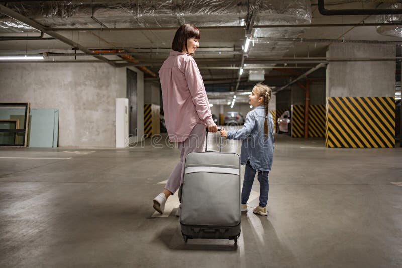 Caucasian Mom And Her Small Daughter Walking Through Underground Caucasian Mom And Her Small Daughter Walking Through Underground