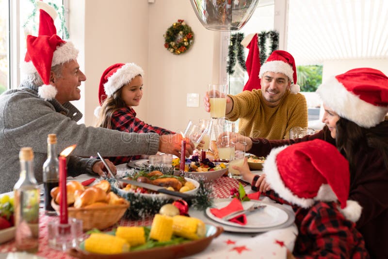 Caucasian Multi Generation Family Wearing Santa Hats Having Christmas ...