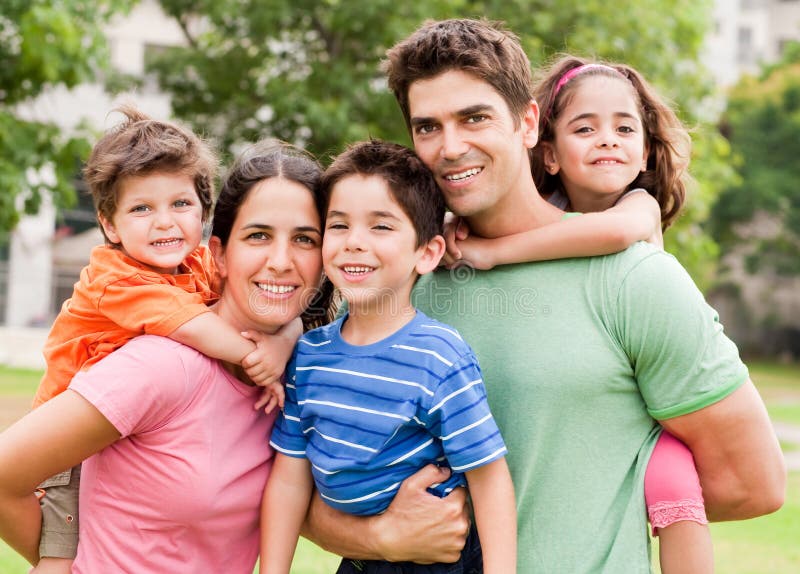 Caucasian parents piggyback their children royalty free stock image