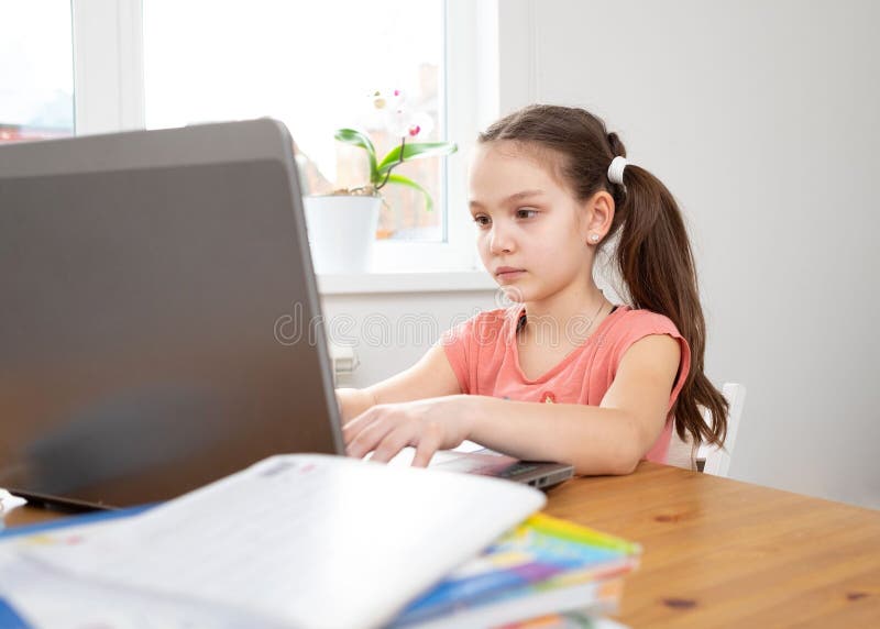 Caucasian preteen girl die op haar taak was toegespitst met een laptop. concept van afstandsonderwijs in isolatie terwijl coronavi