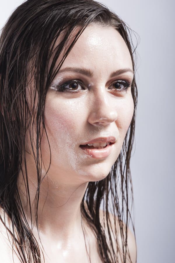 Portrait Of Caucasian Brunette Female Looking Up With Wet And Shining