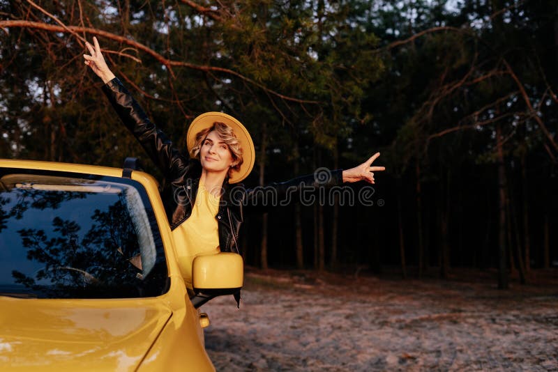 Caucasian Smiling Woman Leaning out of Car Window