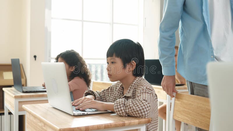 Caucasian teacher helping asian student coding engineering prompt. Pedagogy. stock video footage