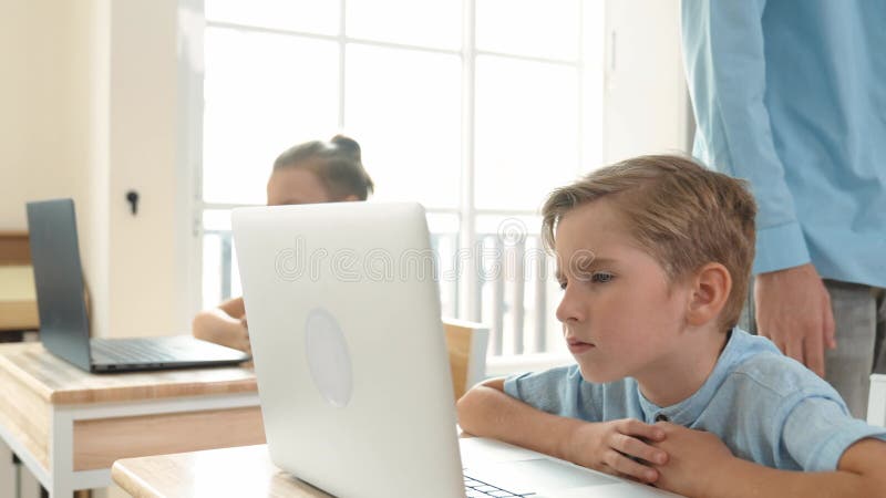 Caucasian teacher helping asian student coding engineering prompt. Pedagogy. stock video