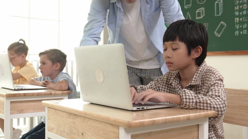 Caucasian teacher helping asian student coding engineering prompt. Pedagogy. stock video footage