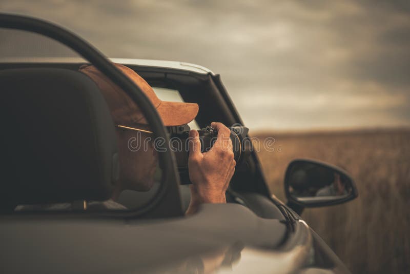 Tourist Taking Pictures From His Convertible Car While on the Road Trip stock photos Tourist Taking Pictures From His Convertible Car While on the Road Trip stock photos