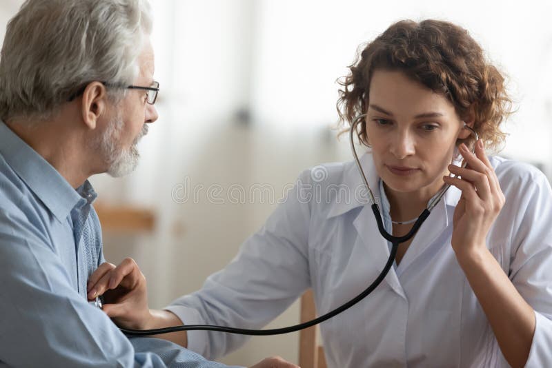 Caucasian woman doctor examine mature patient in clinic