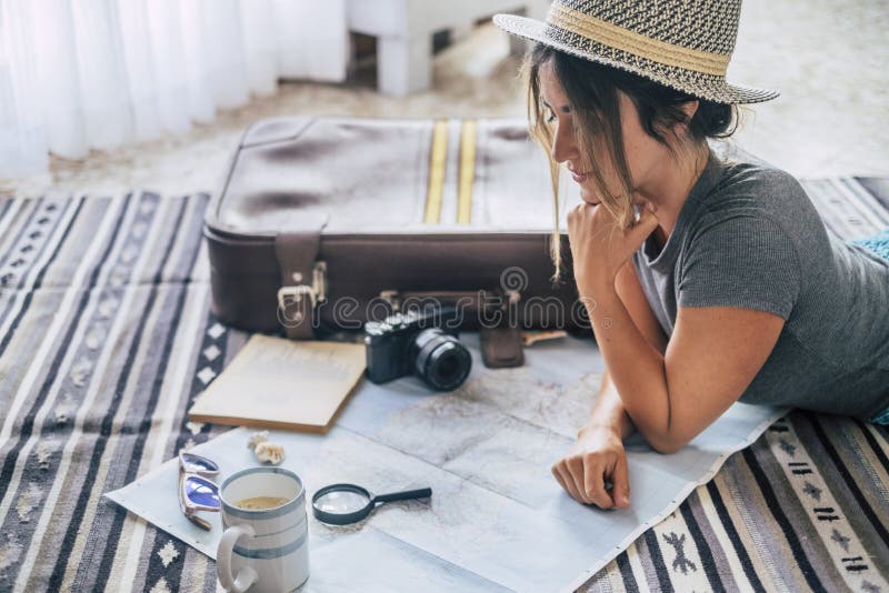 Caucasian woman planning vacation travel with map and guide at home, female people plan next holidays vacation while relaxing