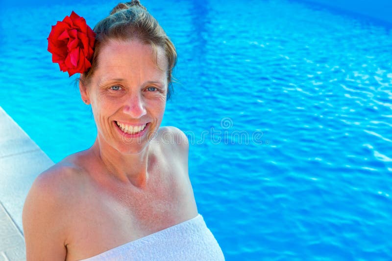 Caucasian woman with rose and towel at swimming pool stock images Caucasian woman with rose and towel at swimming pool stock images
