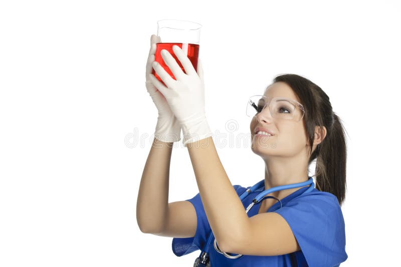 Caucasian woman working as a laboratory technician studing a beaker