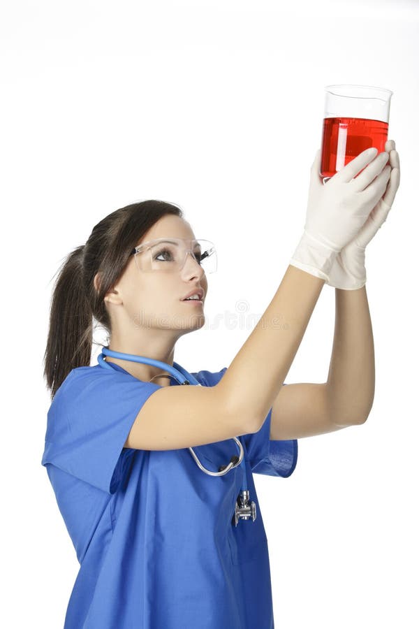 Caucasian woman working as a laboratory technician studing a beaker