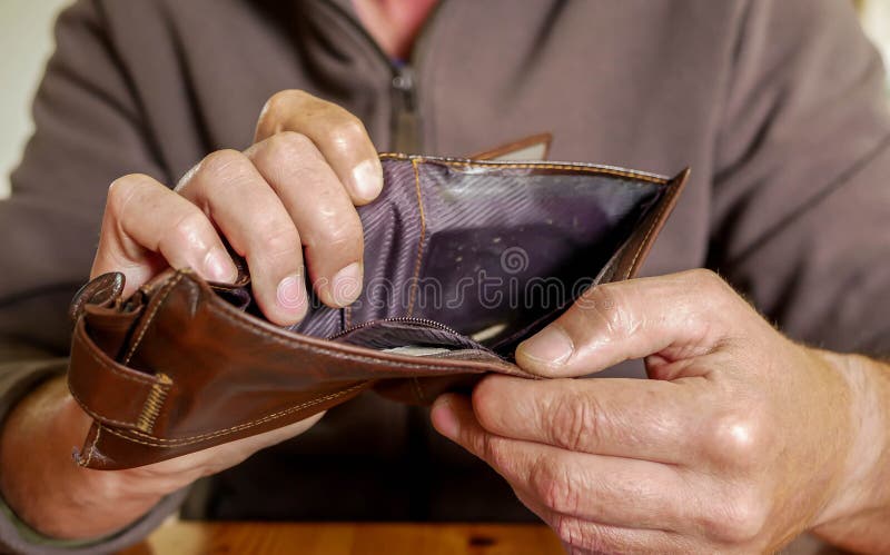 Caucasian worker with a missing finger showing hes empty wallet royalty free stock image.