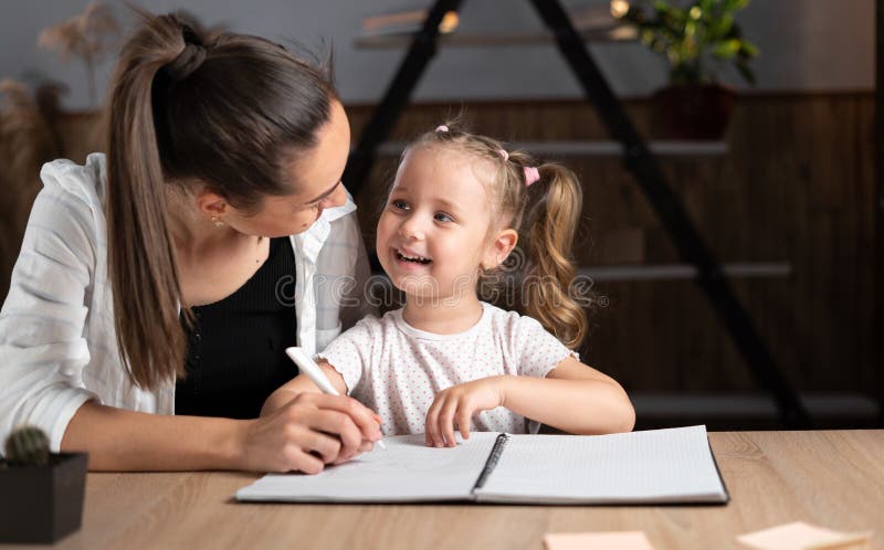 Young Mother Online Caucasian Young Mother and Little Daughter Sitting at the Table in the Evening, Study Online Together Stock Photo - Image of creative, write: 227720976