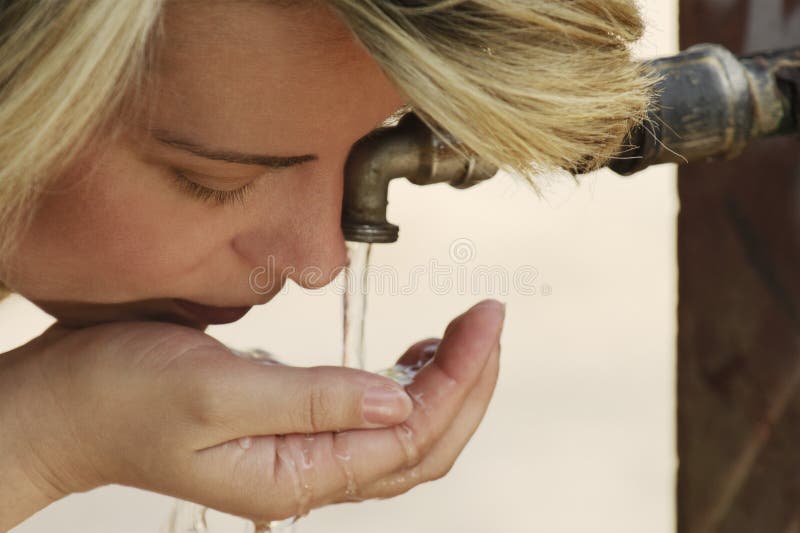 Caucasian young woman drinking water stock images