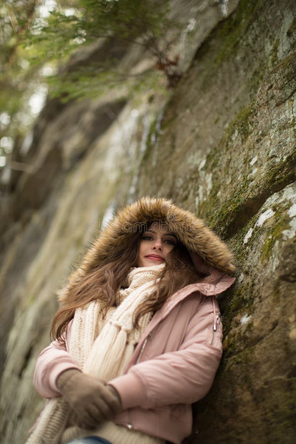 Caucasion High School Senior Leaning Against Natural Rock Wall