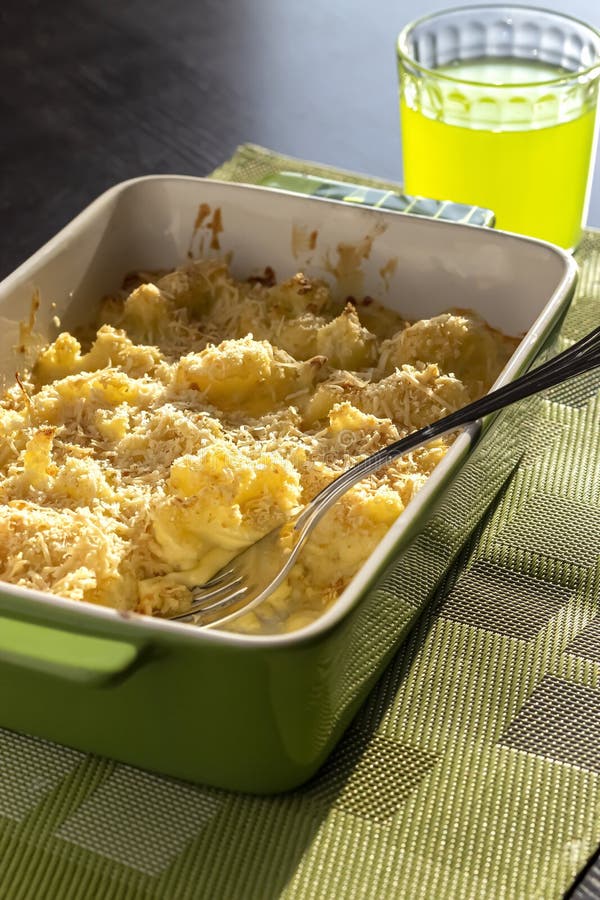 Cauliflower and Cheese Gratin in Green Ceramic Baking Form with Fork. Bright Natural Light Stock