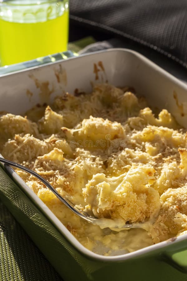 Cauliflower and Cheese Gratin in Green Ceramic Baking Form with Fork. Bright Natural Light Stock