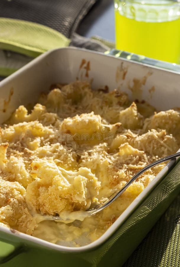 Cauliflower and Cheese Gratin in Green Ceramic Baking Form with Fork. Bright Natural Light Stock