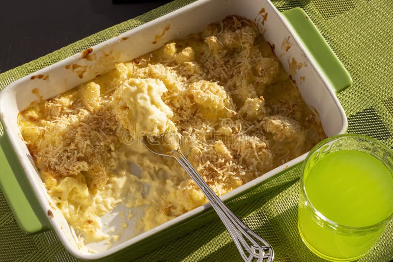 Cauliflower and Cheese Gratin in Green Ceramic Baking Form with Fork. Bright Natural Light Stock