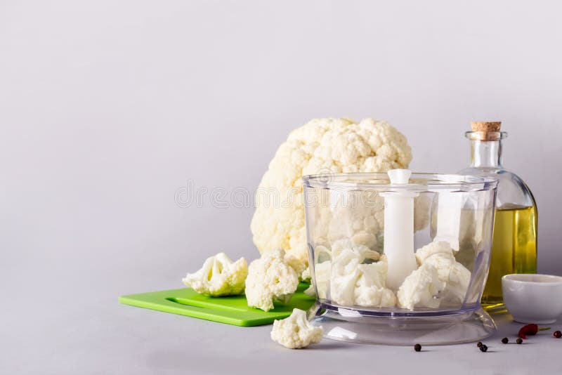 Cauliflower head and blender. Ingredients for Cooking Cauliflower Rice. Paleo cauliflower stock images, royalty-free photos and pictures