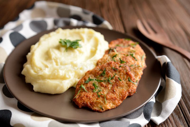 Healthy cauliflower pancakes with mashed potatoes on a wooden background.