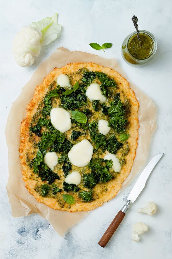 Cauliflower Pizza Crust with Pesto, Kale, Mozzarella Cheese and Greens. Stock Image Image of